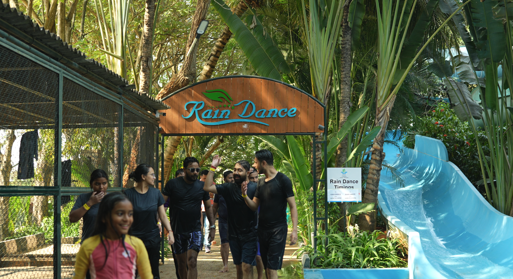 family enjoying slides and rain dance on a dayout at club cabana